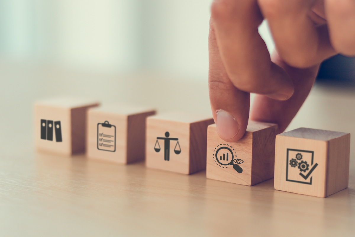 A hand setting a block down with HR icons